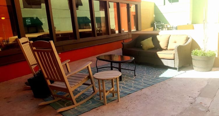 Cozy outdoor seating area with rocking chairs and a sofa