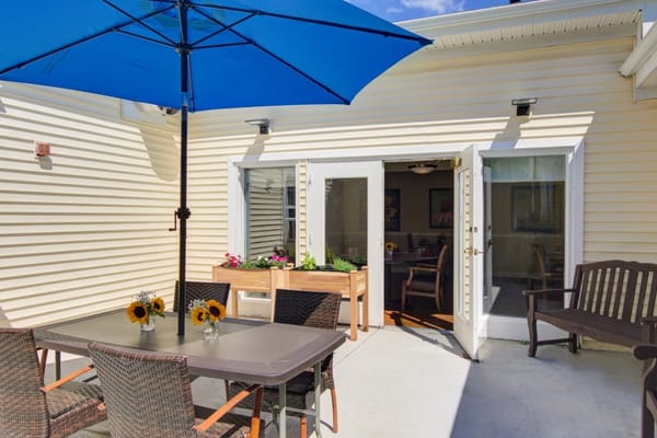Patio area with seating and colorful flowers