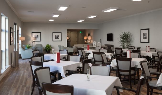 Bright dining room with tables set for meals