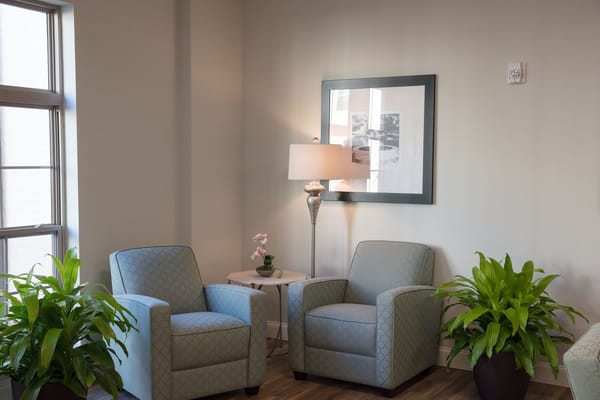 Cozy interior seating area with plants and artwork