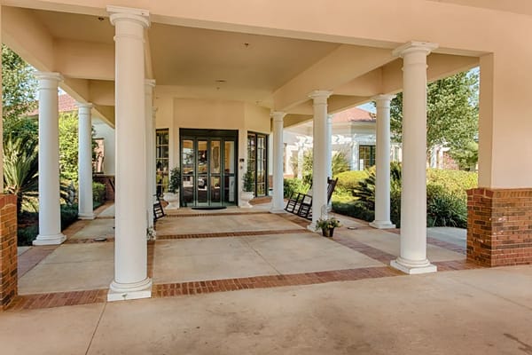 Entrance of The Brennity at Daphne with rocking chairs