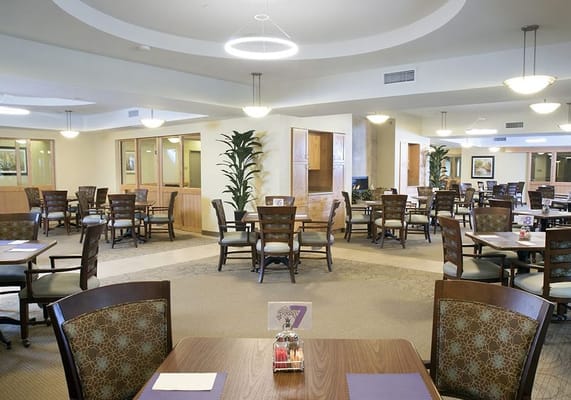 Spacious dining area with tables and chairs at The Brielle senior living facility.