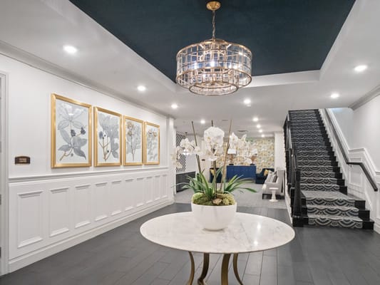 Brightly lit common area with decorative art and flowers