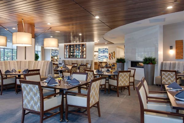 Bright dining room with tables set for meals
