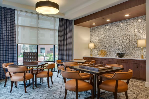 Bright common area with tables and chairs