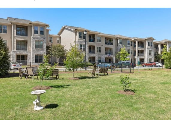 Lush garden area with seating in front of residential building
