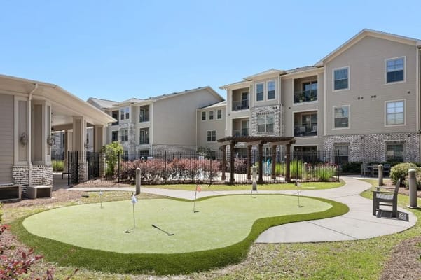 Miniature golf area surrounded by residential buildings