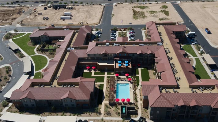 Aerial photo of The Enclave senior living facility showcasing the pool and surrounding grounds.