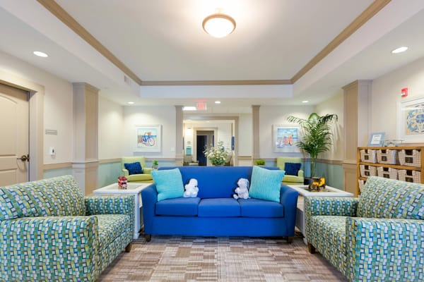 Colorful lounge seating area with blue and green couches