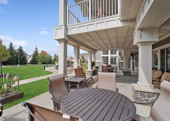 Outdoor patio area with seating and a lawn