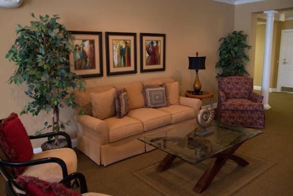 Comfortable seating area in a well-lit living room with art