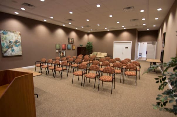 Empty community room with chairs arranged for an event