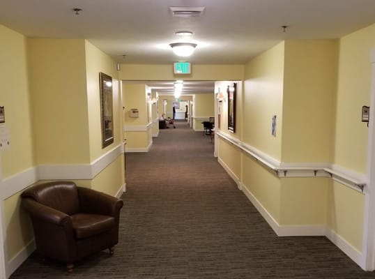 Interior hallway with a chair at The Gables of Ammon