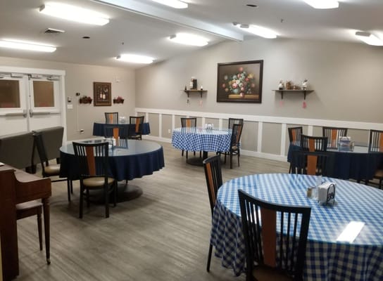 Dining room with checkered tablecloths and seating arrangements