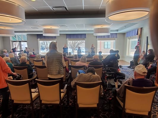 Residents enjoying a live performance in a lounge area