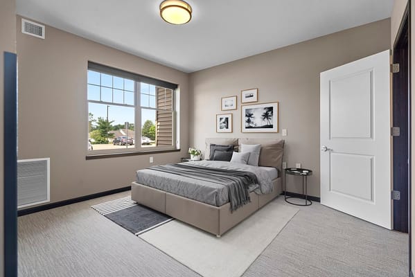Cozy bedroom with a bed, window, and decorative photos