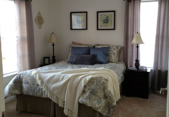 Cozy bedroom with floral bedding and natural light
