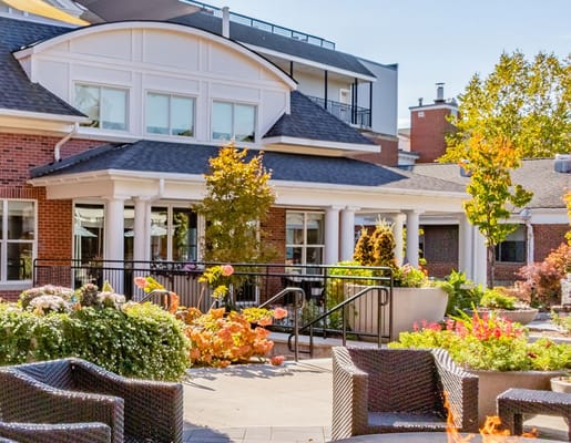 Patio area with flowers and seating at The Hunt Community