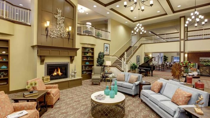 A spacious lobby with comfortable seating and a fireplace.