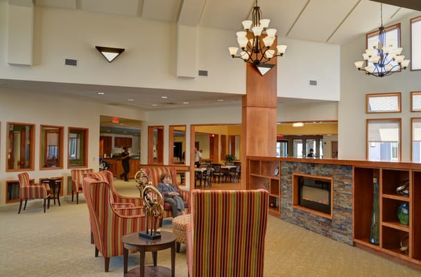 Comfortable seating area with striped chairs and a fireplace