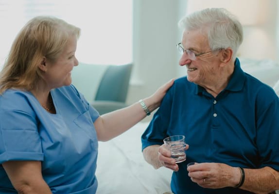 Staff member interacting with a resident in a room