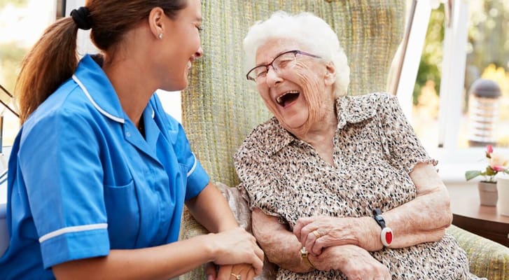 A caregiver sharing a joyful moment with a resident