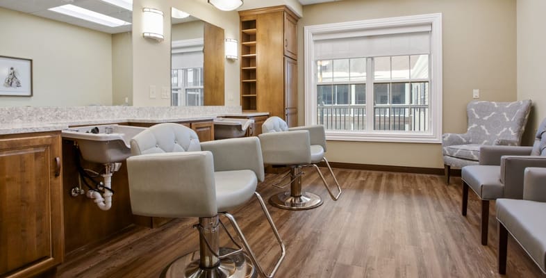 Salon area with hair styling chairs and a large window