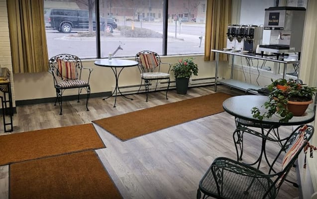 Lounge area with seating, potted plants, and an ice machine.