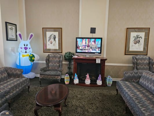 Living room setting decorated for spring with an inflatable bunny and colorful eggs