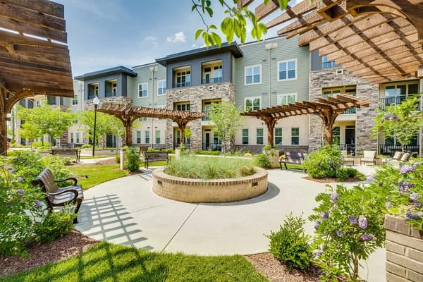Serene courtyard with benches and landscaping at The Reserve at Mills Farm