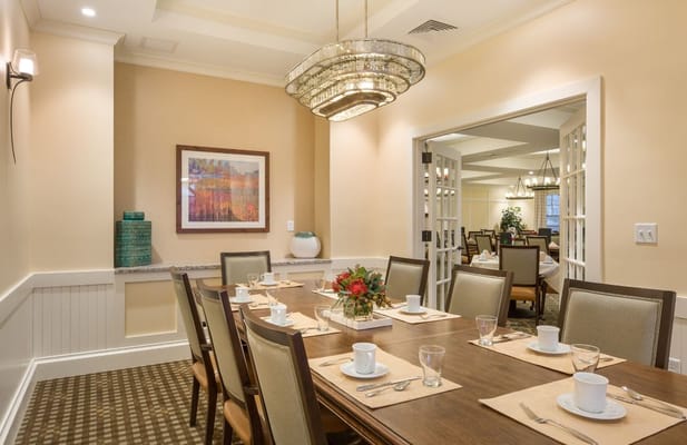 Elegant dining room set for meals at The Residence at Orchard Grove.