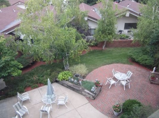 Outdoor patio area with seating and landscaping