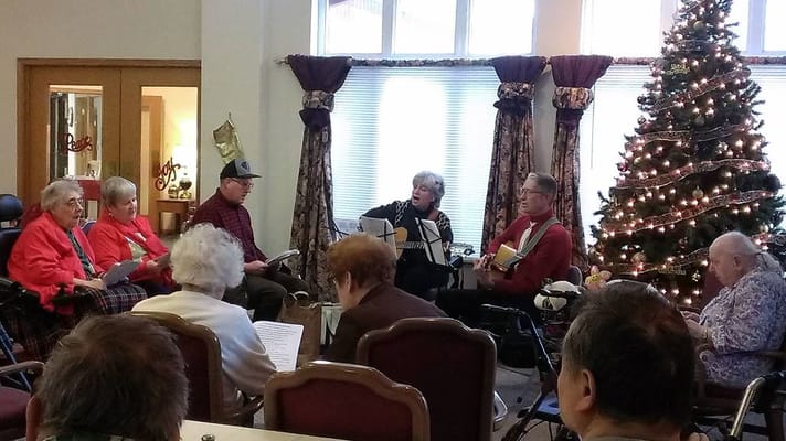 Residents enjoying a musical activity during the holidays