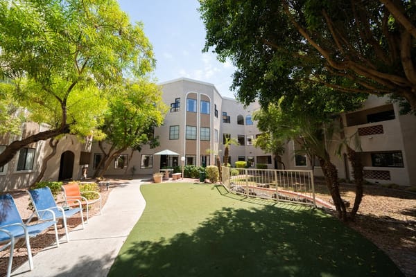 Courtyard with green lawn and seating at The Springs of Scottsdale