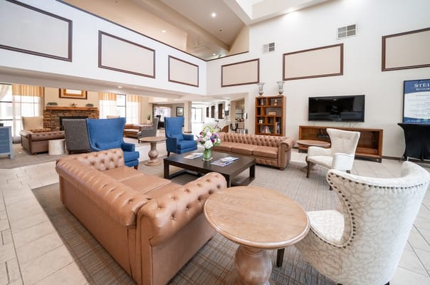 Spacious lobby featuring comfortable seating and a decorative coffee table.