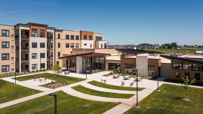 Aerial view of The Summit at Bettendorf showcasing its architectural design and landscaped outdoor area.