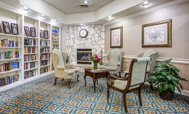 Lounge area with chairs, a coffee table, and bookshelves
