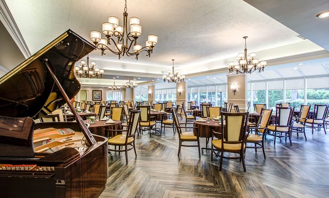 Elegant dining room with piano and chandeliers