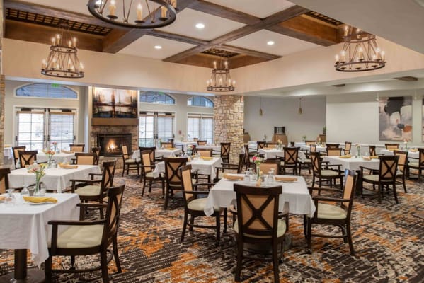 Bright and inviting dining room with tables and chairs ready for residents