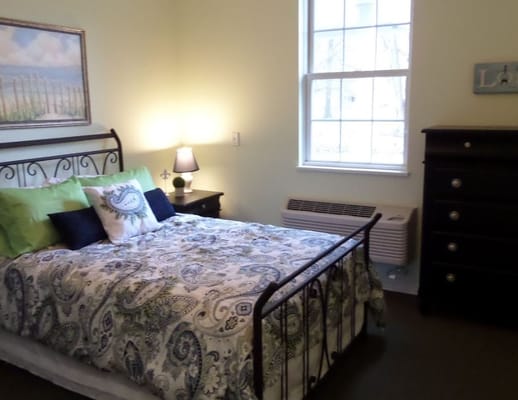 Cozy bedroom setup with decorative bedding and lamp