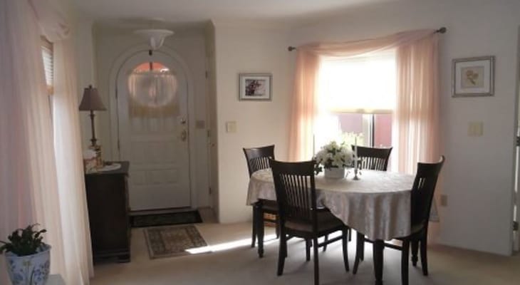 Dining area with a table and chairs near the entrance