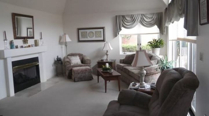 Bright and inviting living room with comfortable seating and a fireplace