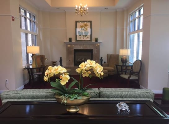 Living room with orchids and a fireplace