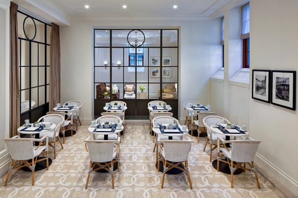 Dining area with tables and chairs set for meals