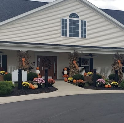 Front entrance of a senior living facility decorated for fall