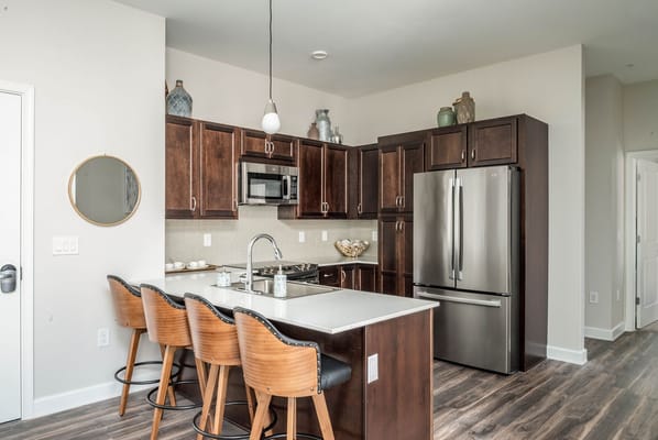 Stylish kitchen with dark wood cabinets and modern appliances