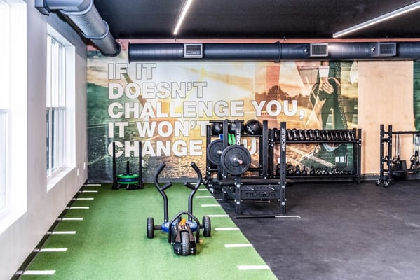 Well-equipped gym with exercise equipment and motivational wall art