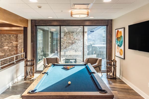 Billiards table in a well-lit lounge area