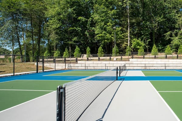 Tennis court with net and green surroundings