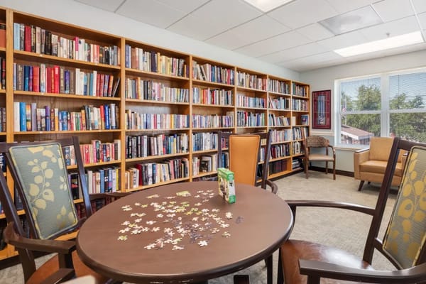 Interior view of the library with bookshelves and puzzle table